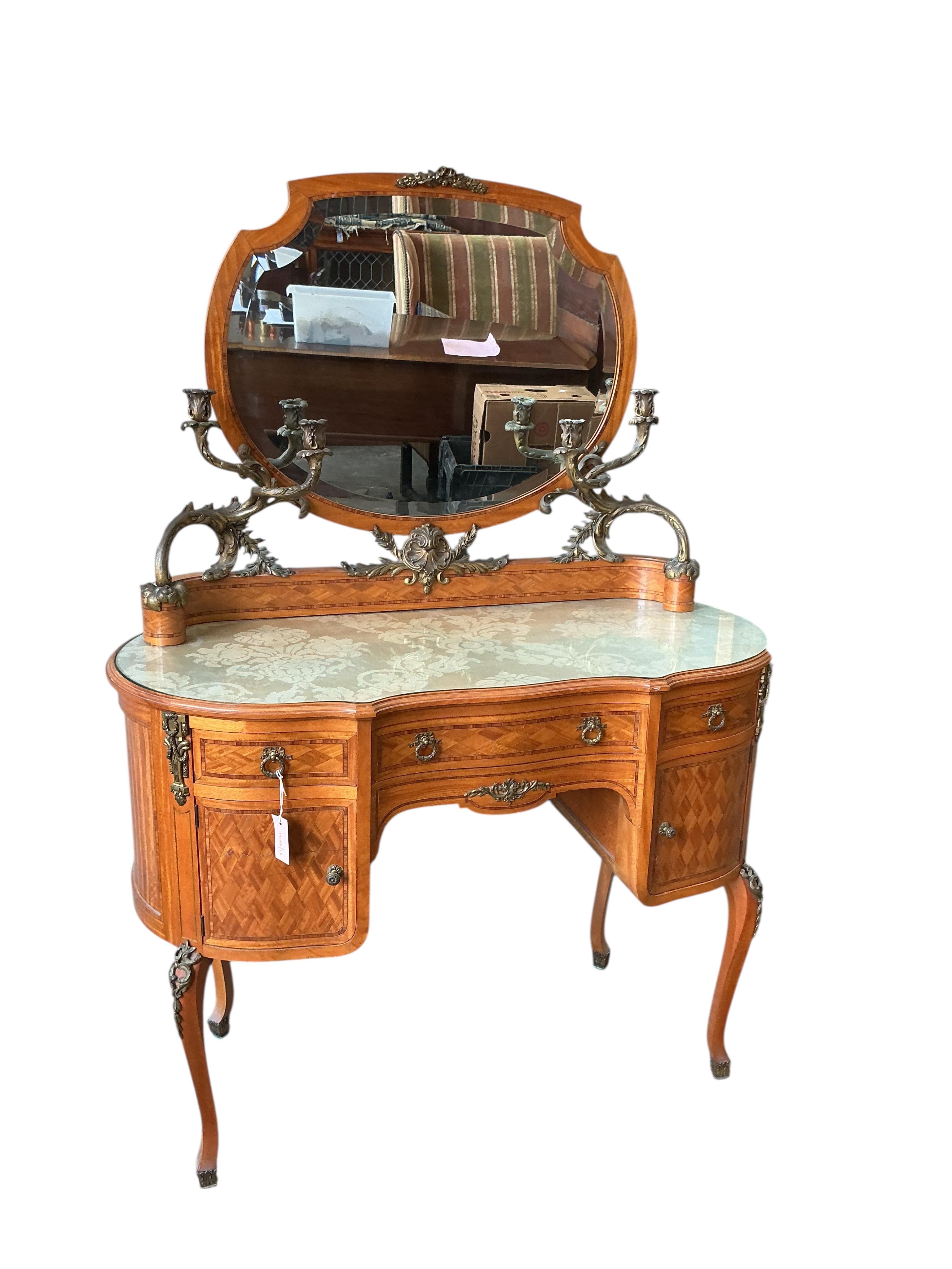 An early 20th century French transitional style gilt metal mounted tulip banded and parquetry inlaid kneehole dressing table, width 115cm, depth 50cm, height 160cm